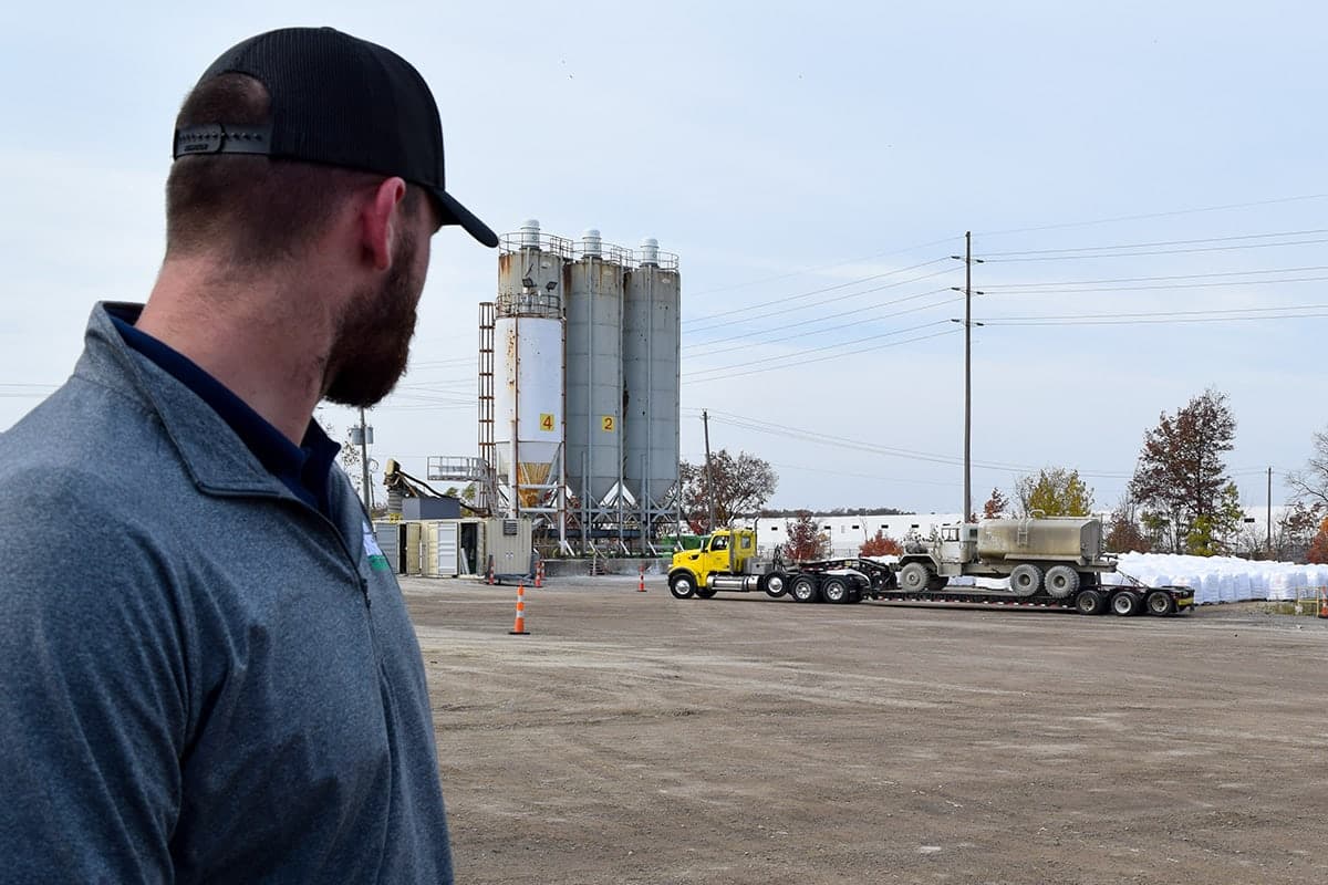 Cem-Base employee standing in front of cement mixing plant