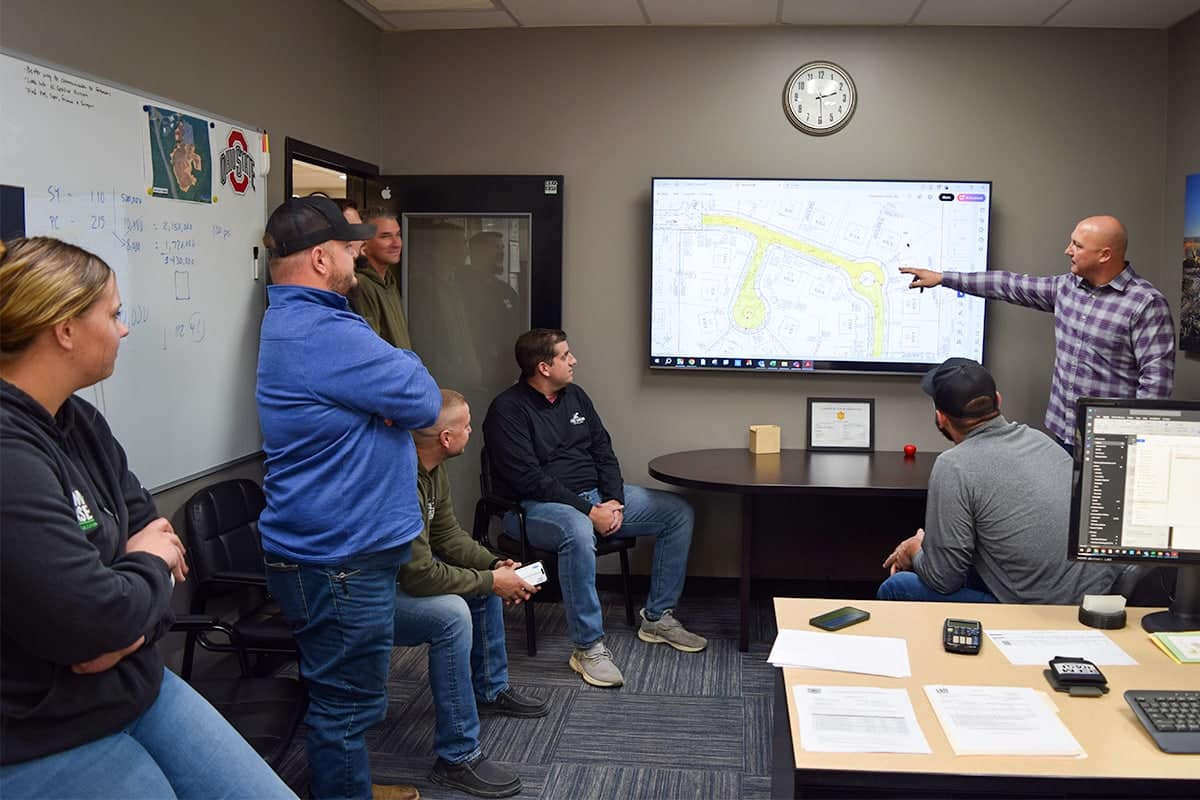 Group of Cem-Base employees analyzing roadway blueprints