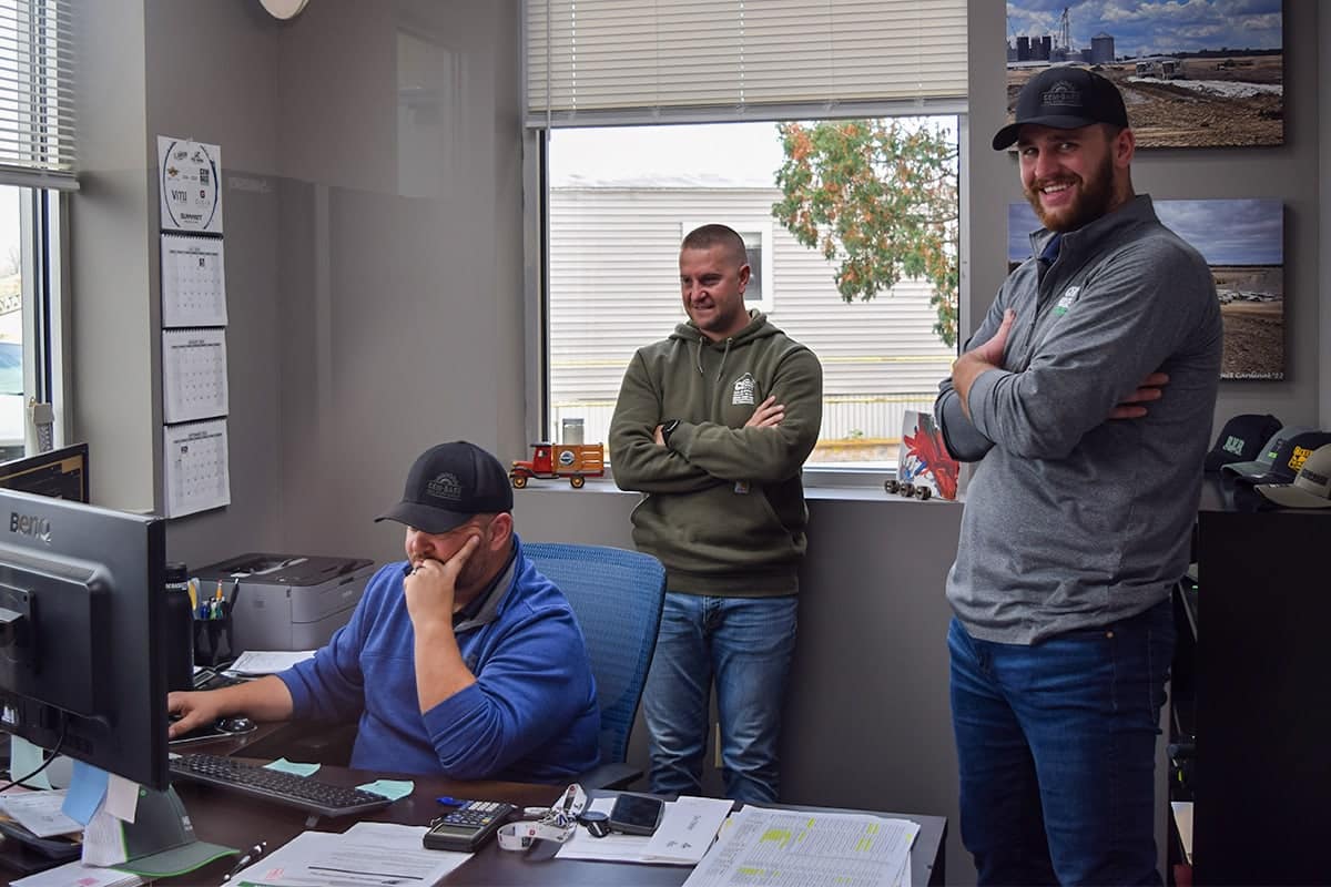 Group of Cem-Base employees looking at project specifications on computer screen